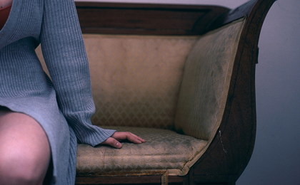 An image of a girl on a sofa.