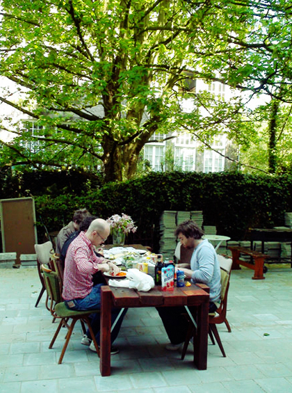 An image of everyone eating outside in the garden.