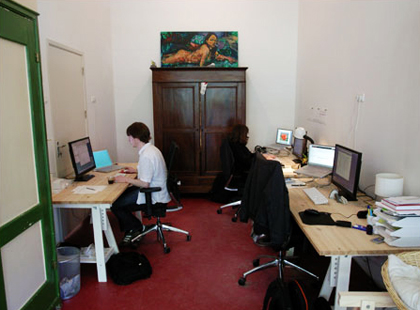 An image of a couple of more desks next to the kitchen.